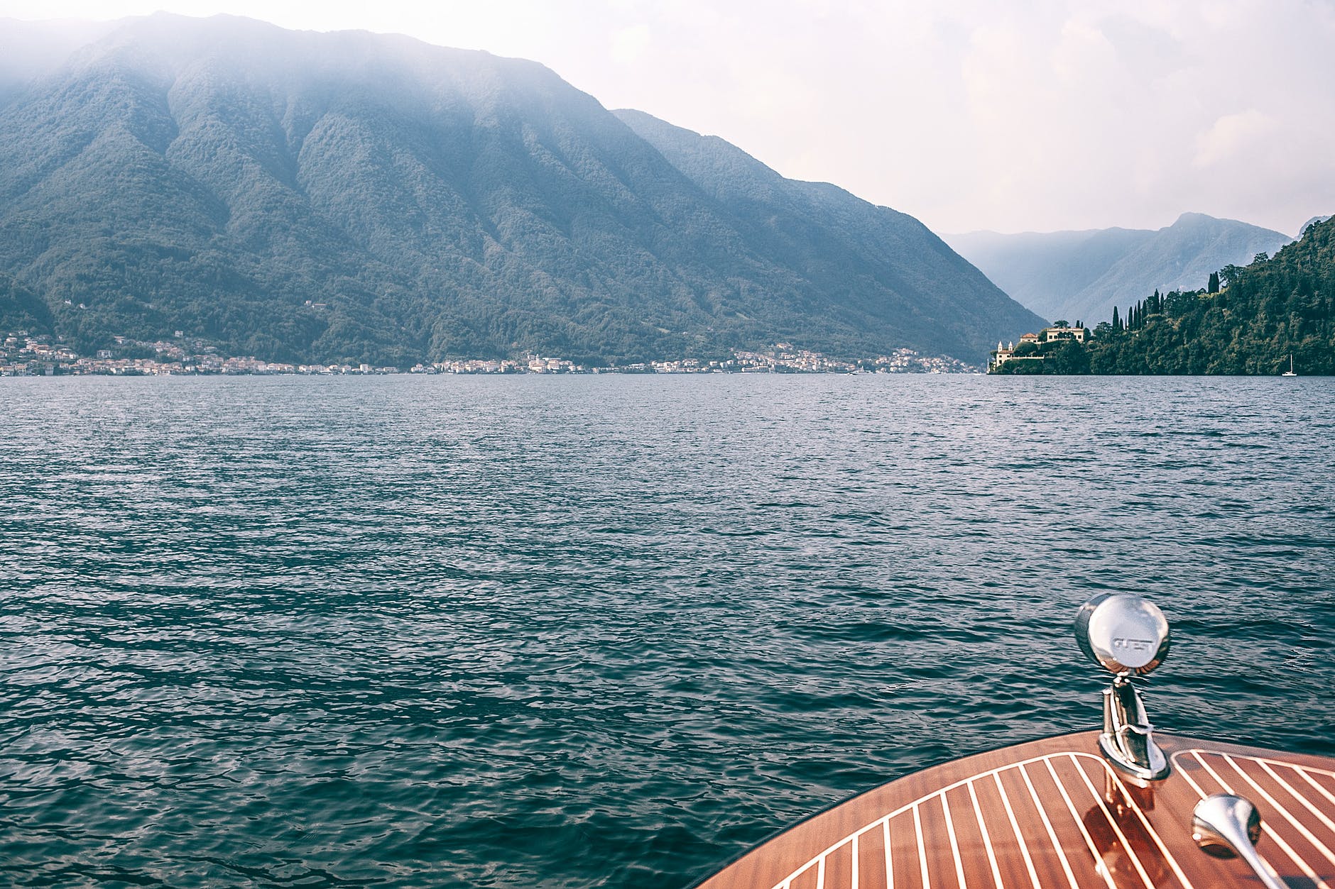 deck of boat on lake against high mountains