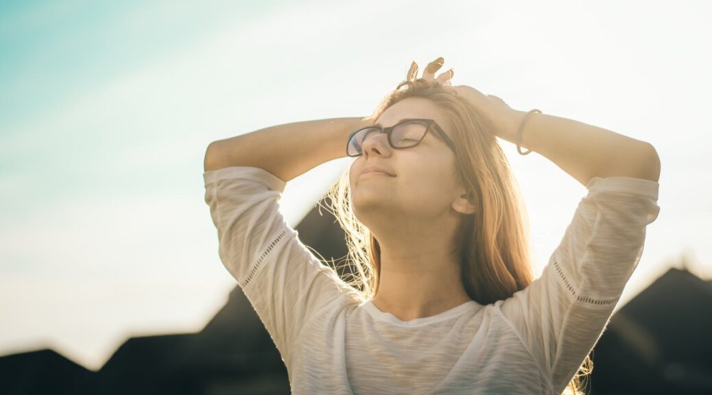 photo of woman holding her head